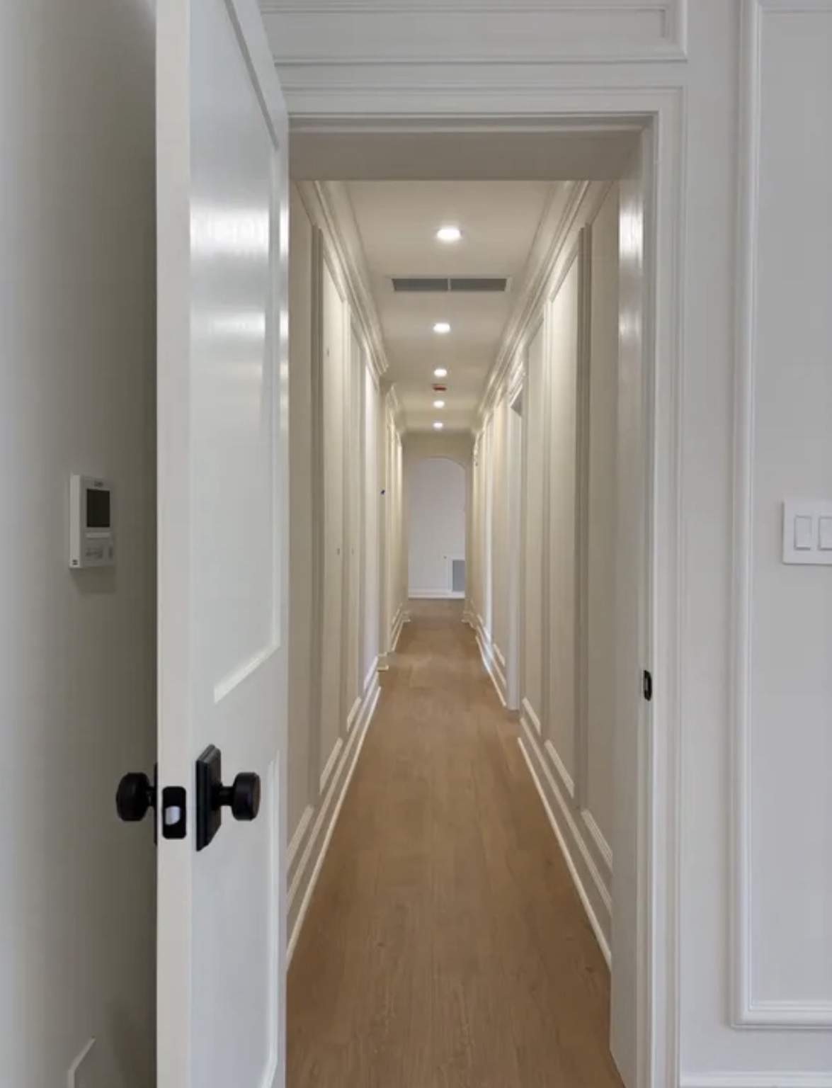 Long hallway with detailed casing and trim